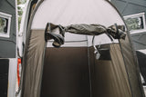 RV rental camper van's outdoor privacy shower tent, shown attached to the rear. The brown tent interior has a visible shower head.