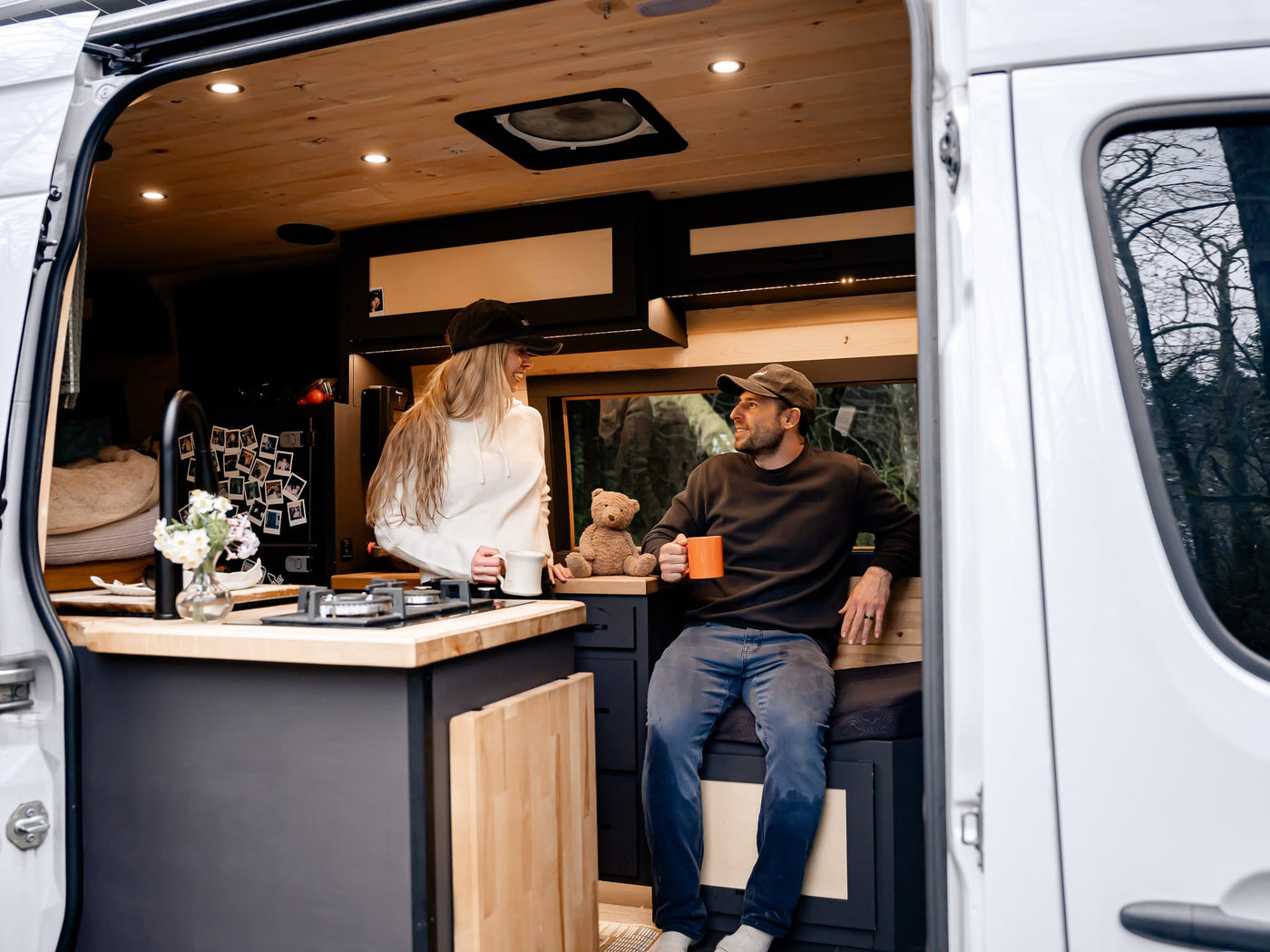 perfect for an RV rental camping trip.|Smiling couple enjoying their modern RV rental's interior — photo 2