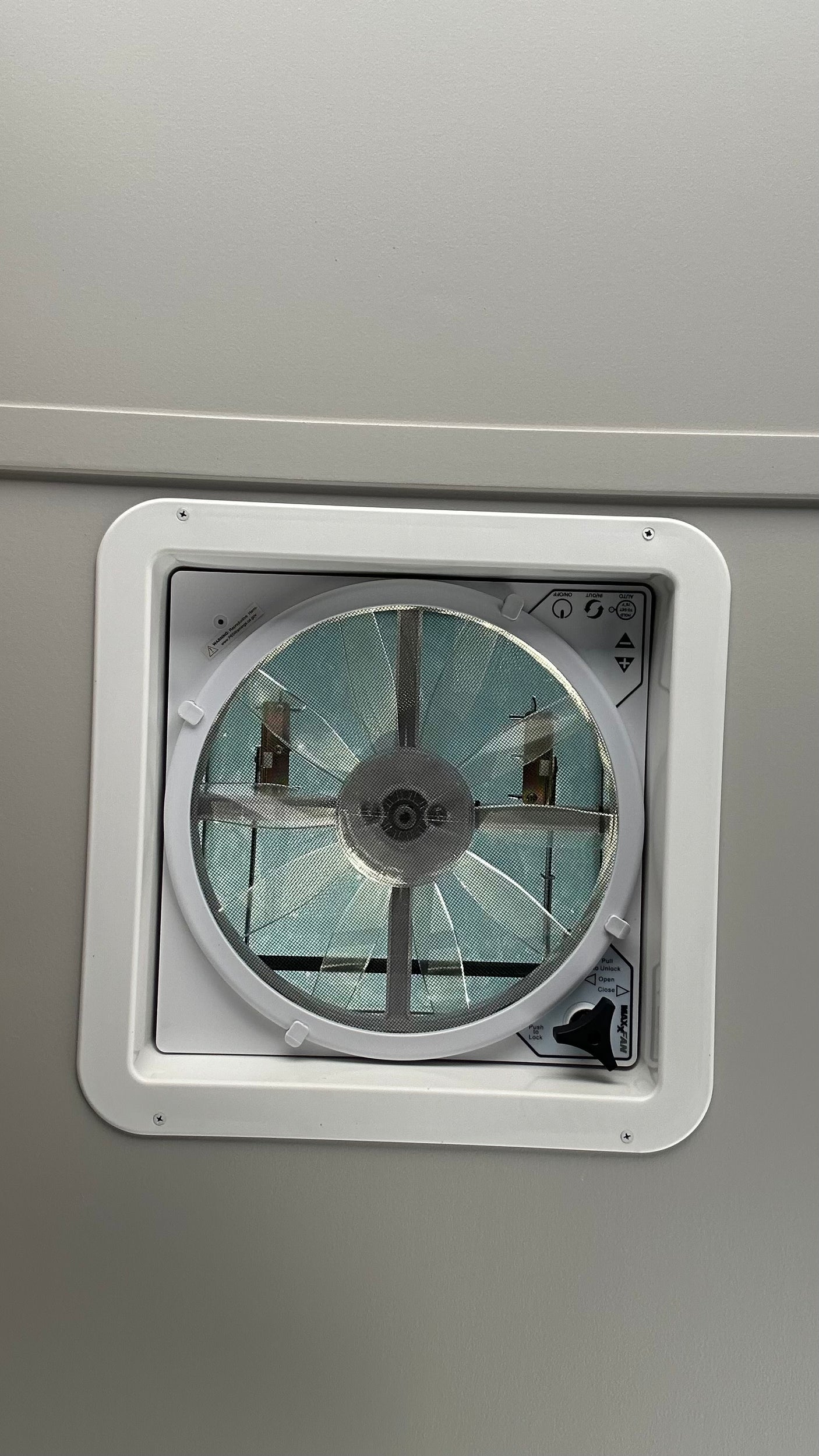 A white Maxxair fan/vent, an essential feature inside this RV rental for ventilation and comfort.