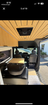Explore this modern rv rental camper van: light wood interior, cozy dining area, and spacious design for your road trip.
