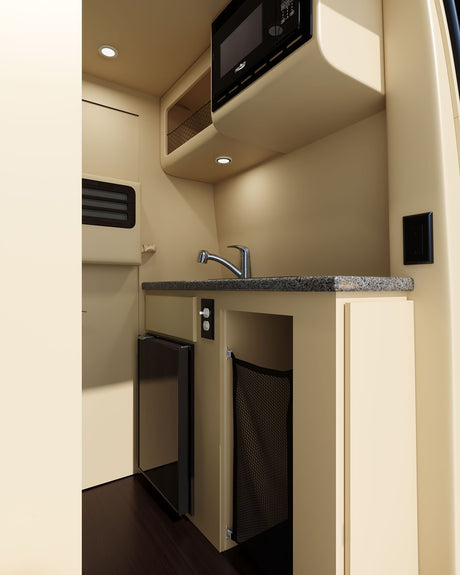 Compact RV rental kitchen interior with microwave, sink, and fridge, ideal for travel.