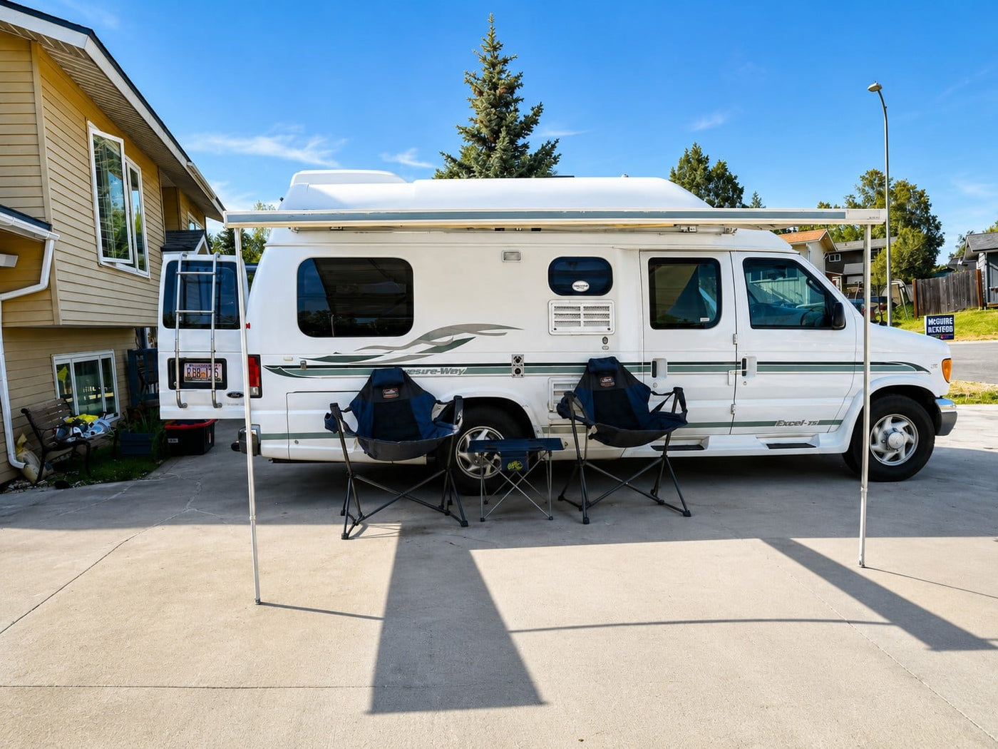  and bright windows with outdoor views.|White Pleasure-Way Excel-TS camper van parked outside on a sunny day. This RV is ideal for your next rv rental adventure.|A white camper van — photo 4