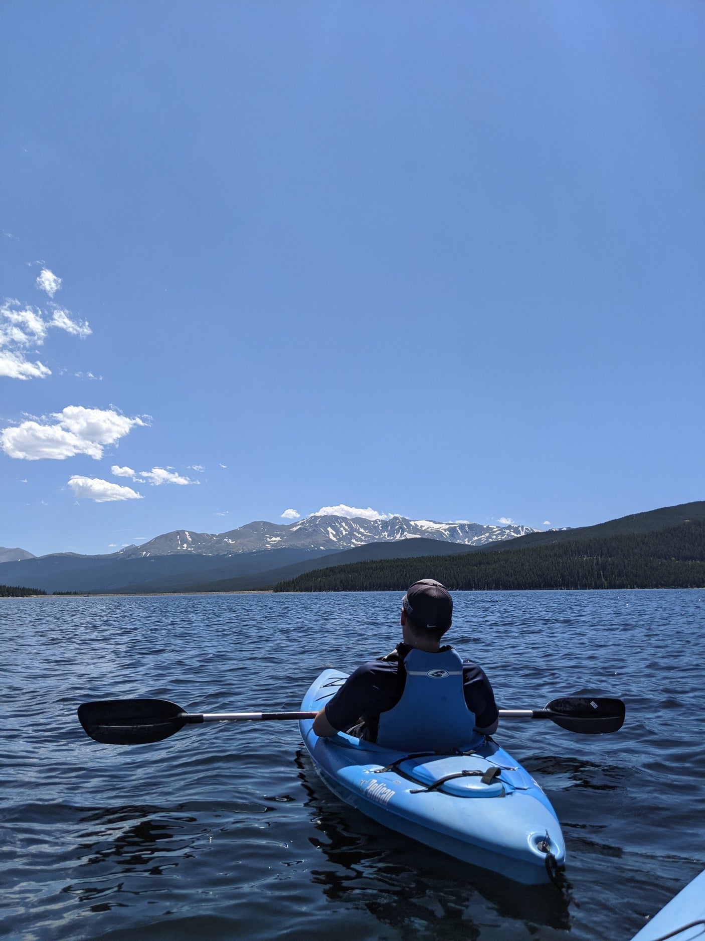 Kayaking on a scenic mountain lake, a perfect RV rental adventure.