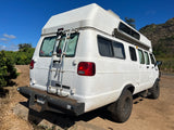 White high-top **RV rental** camper van with rear ladder and off-road tires, perfect for Hawaii adventures.