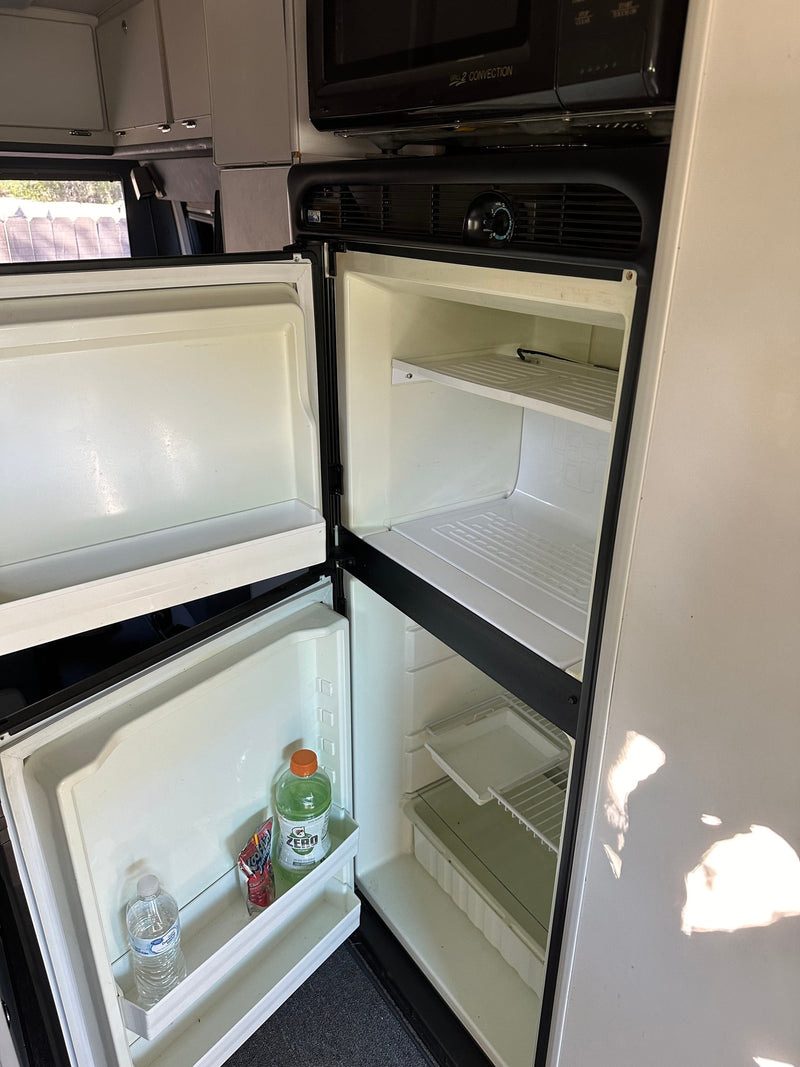  and a fitted cutting board. Perfect for travels.|RV rental: Spacious interior from rear — photo 10