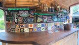 RV rental kitchen: Custom Oregon travel map drawn on chalkboard, vibrant tiled backsplash, wooden counter, and sink.