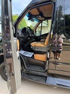  & window views for your journey.|Inside a sleek RV rental: modern dashboard with a large touchscreen showing apps — photo 12