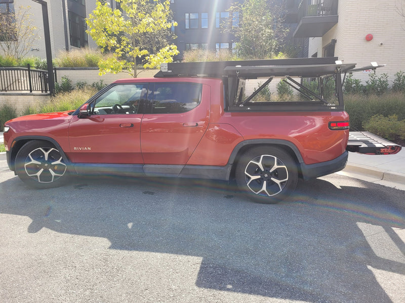 parked on a sunny day.|Red Rivian R1T electric truck with a GFC camper and rooftop tent — photo 13