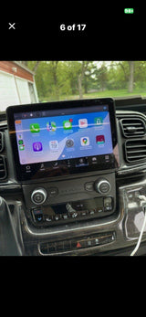Inside an RV rental: a modern dashboard featuring a large touchscreen with apps, plus climate and audio controls.