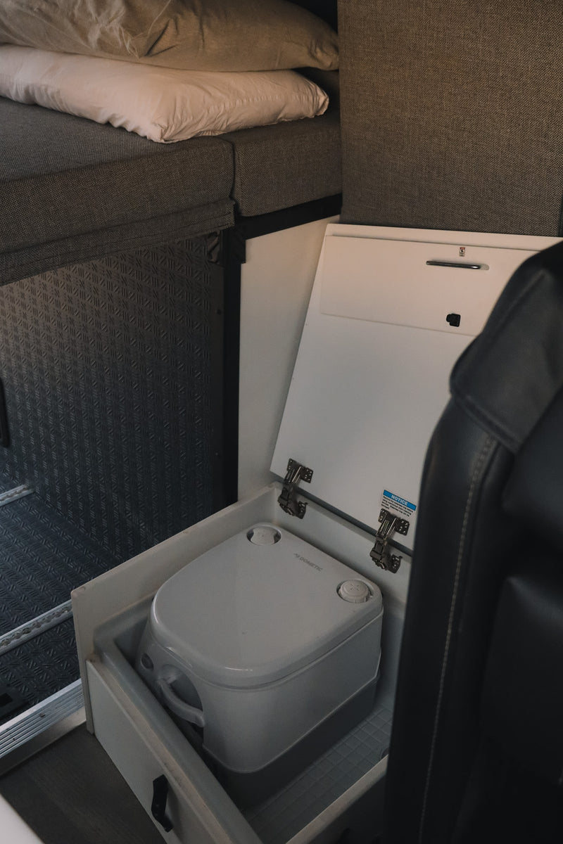  and ceiling AC unit.|Cozy RV rental interior with a comfortable bed and pillows — photo 8
