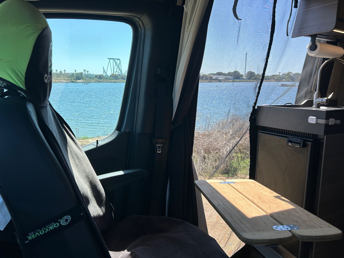  and essential off-road recovery gear like traction boards.|RV rental van interior features a comfy bed — photo 6