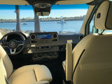 Enjoy the view! RV rental interior of a Mercedes Sprinter with dashboard, looking out at a scenic Long Beach waterfront.