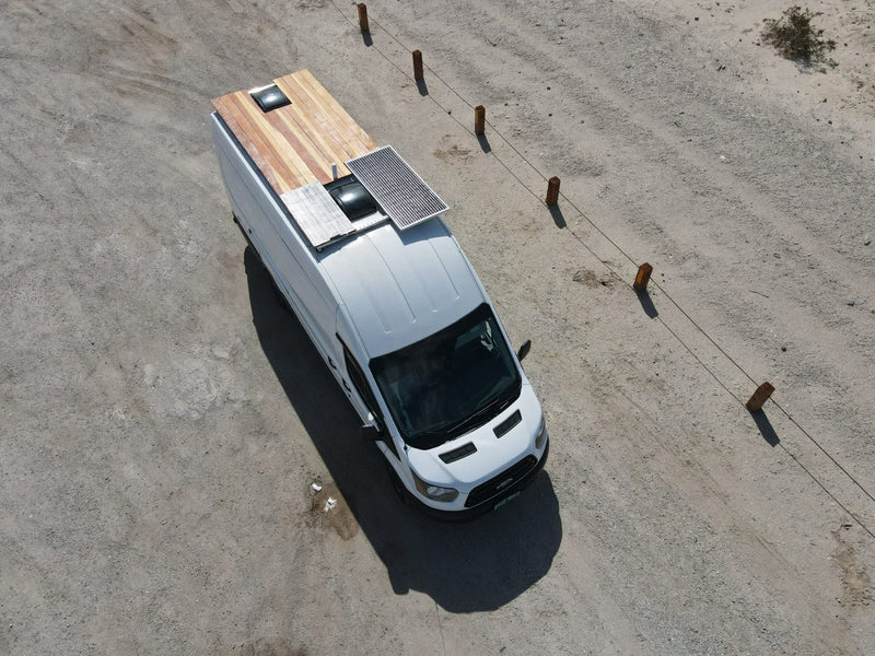  and compact bedroom with brown leather seating.|Stylish RV rental with a compact navy kitchen — photo 3