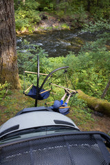 Overhead view: Relaxing in portable chairs by a serene river, next to an rv rental. Ideal for nature lovers.