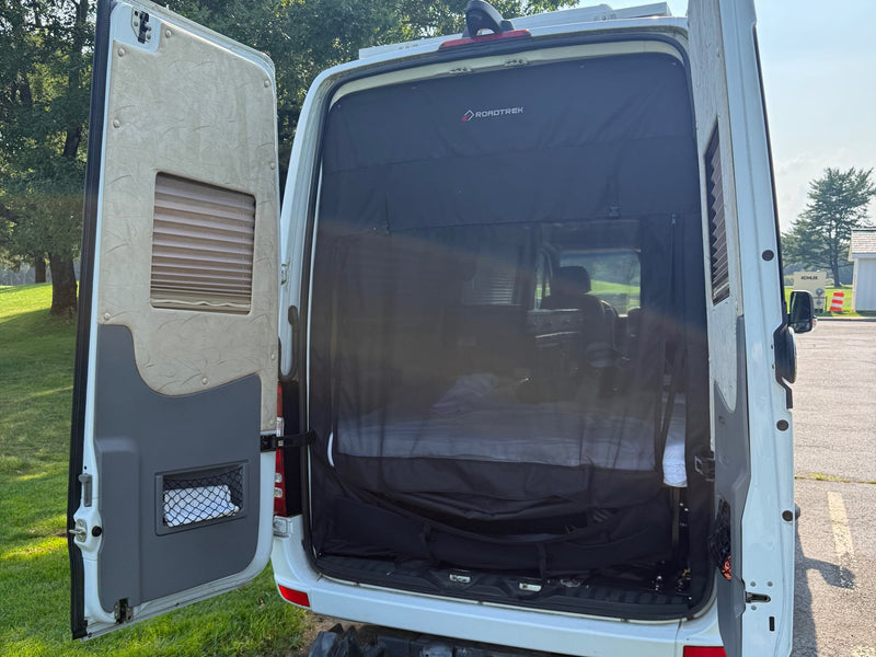  and chrome trim detail.|Open rear doors of an rv rental Roadtrek camper van — photo 10