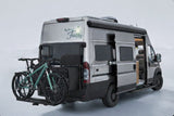 "Rolling Faith" gray RV rental with bikes on a rear rack, side door open, ready for outdoor adventures.