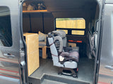 This RV rental offers family-friendly travel with a child safety seat, bed, and smart storage in its camper van interior.