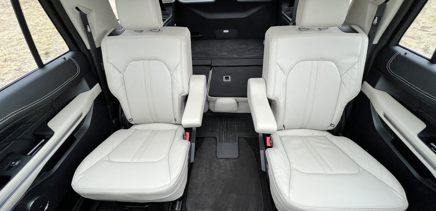 Spacious vehicle interior, ideal for rv rental. Two comfortable captain's chairs with armrests and ample rear cargo space.