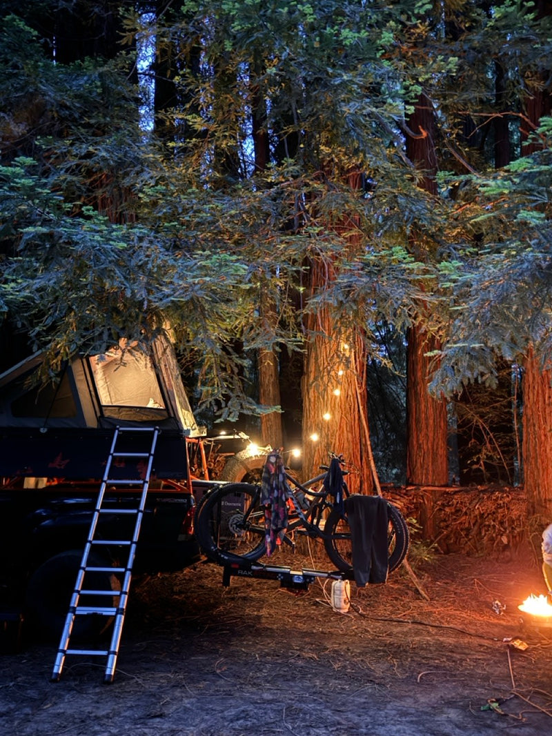  grassy plain. Explore with an RV rental!|Truck with rooftop tent for camping. Cooking outdoors — photo 1