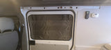 RV rental interior featuring a window with insulated cover, remote, and carbon monoxide detector for comfort and safety.