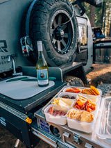 RV rental outdoor kitchen: wine, charcuterie, & a 'COOK PARTNER' unit for gourmet camp meals.