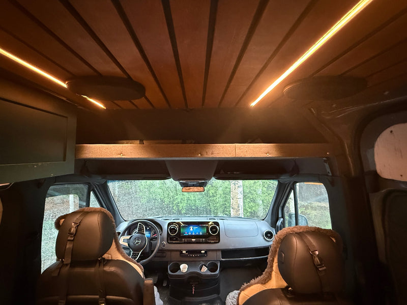  and versatile seating.|Explore this modern RV rental! Features a teal kitchenette with wood accents — photo 9