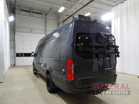 Rear view of a dark gray Mercedes-Benz Sprinter camper van with a bike rack, ideal for an rv rental.