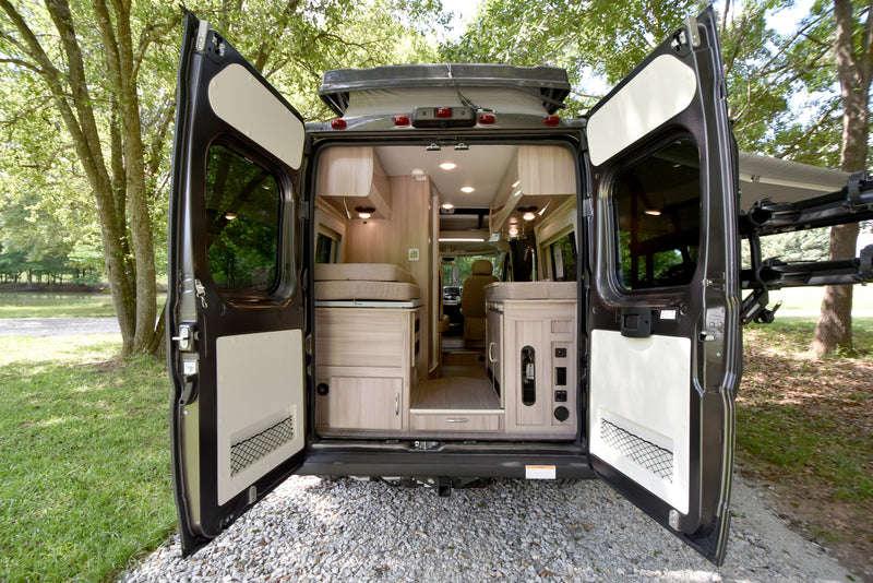 Spacious RV rental interior and scenic outdoor view from open rear doors, perfect for camping. — photo 13