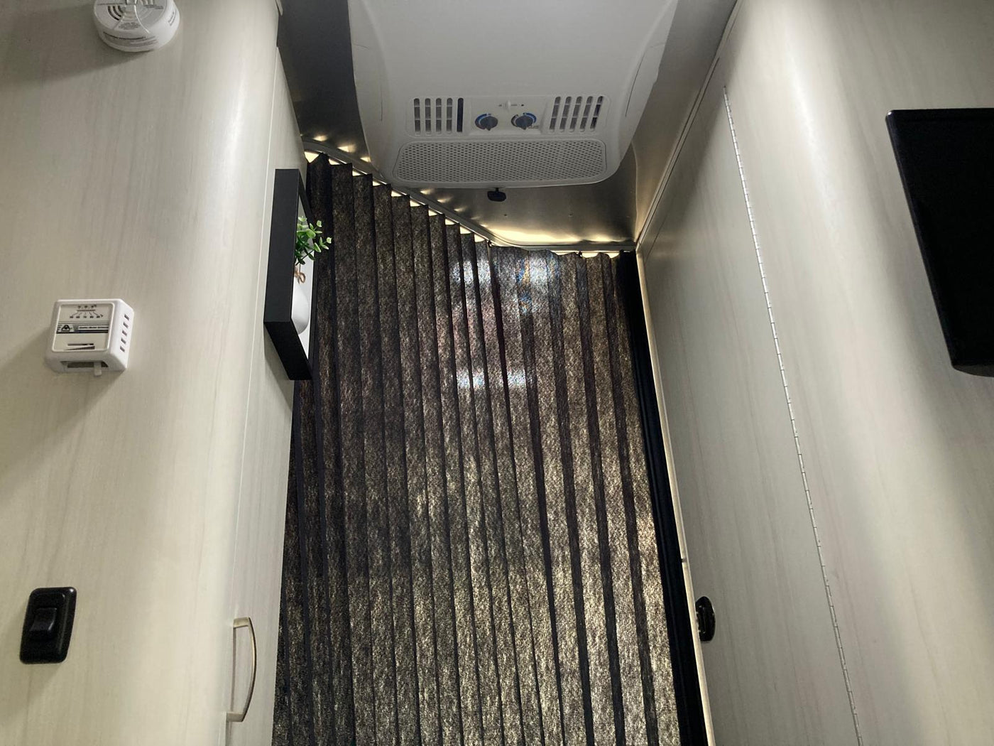  has its awning extended for shade.|This RV rental floor plan shows a compact travel trailer with a dinette — photo 8