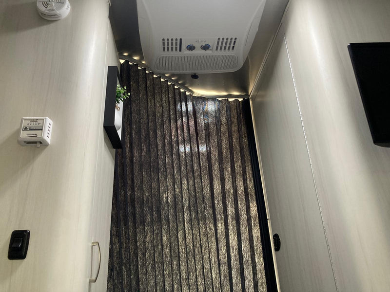  has its awning extended for shade.|This RV rental floor plan shows a compact travel trailer with a dinette — photo 8
