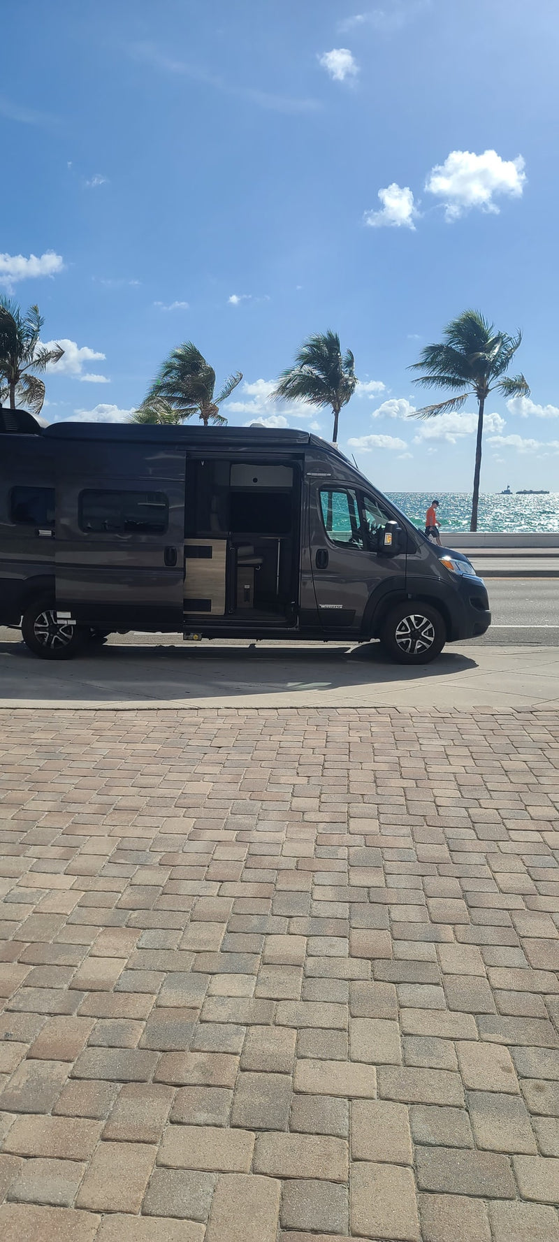  parked on a street in front of a grand building.|An RV rental van's inviting interior: driver's seat — photo 3