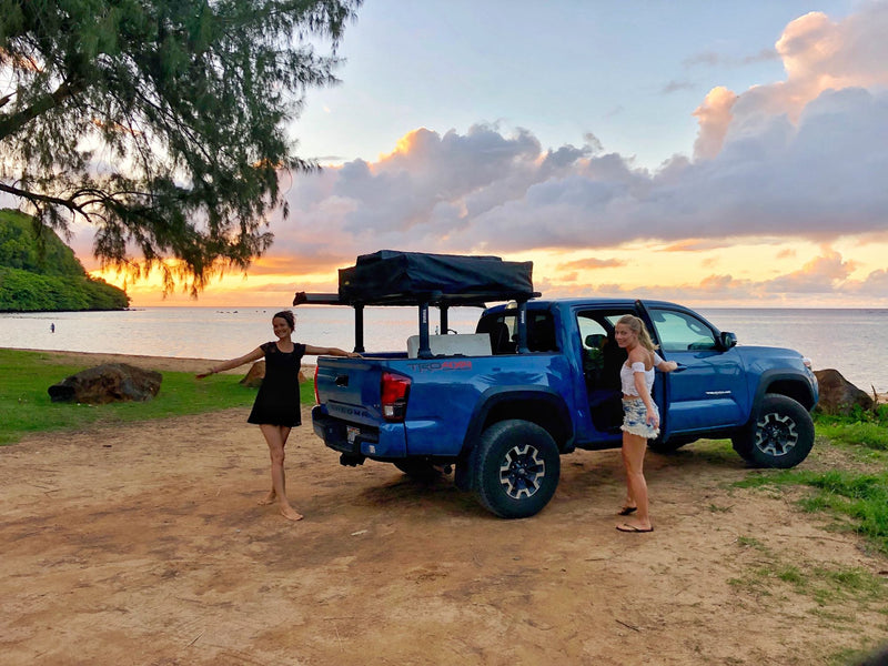 RV rental adventure! Two women pose with a blue truck and rooftop tent at a beautiful sunset beach. — photo 7