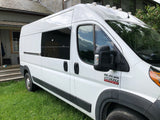 White Ram ProMaster camper van for rv rental, parked on grass. Custom windows & roof lights visible.