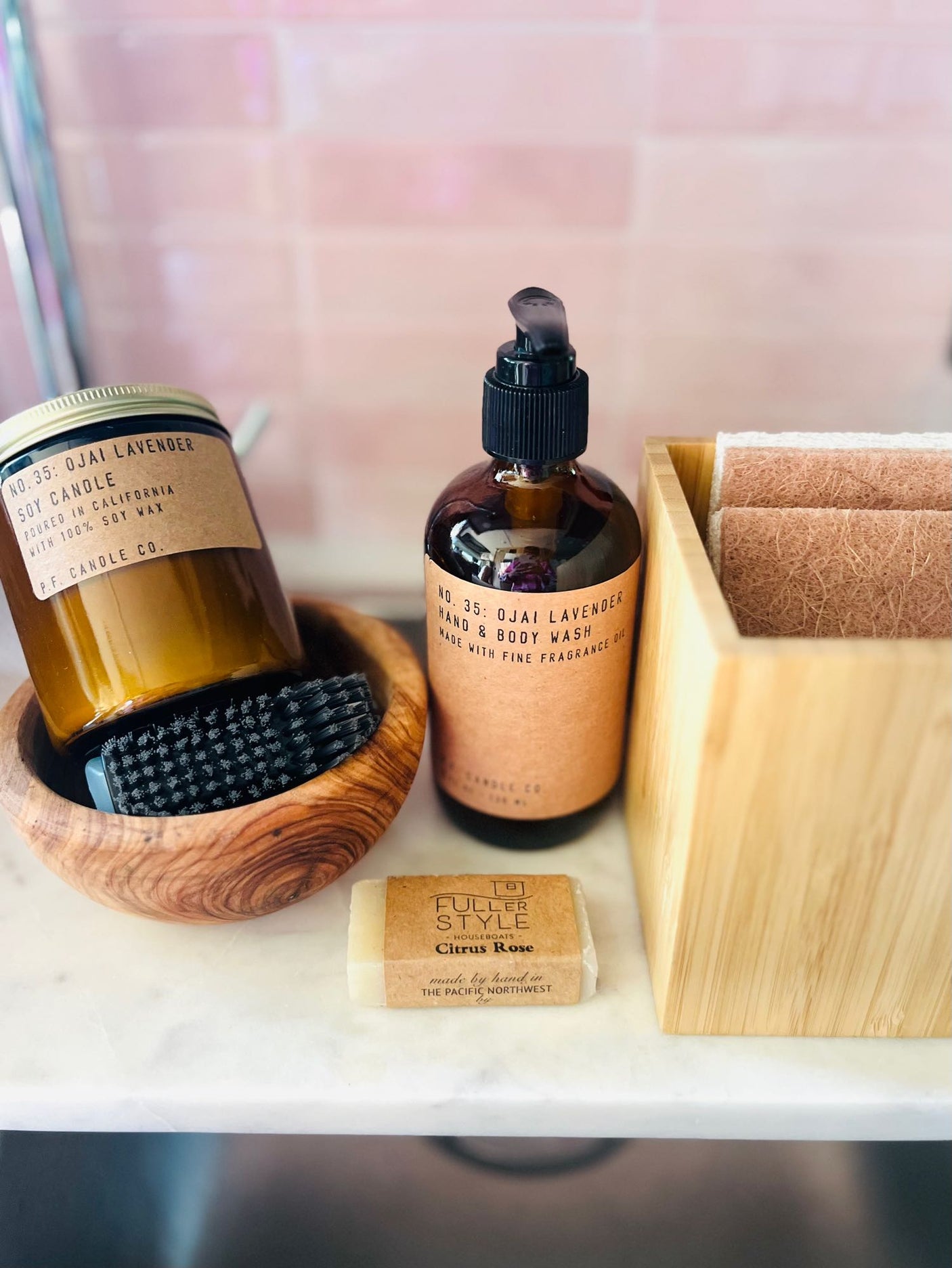 Ojai Lavender candle, hand wash, Citrus Rose soap, and sponges – practical eco-friendly essentials for your RV rental.