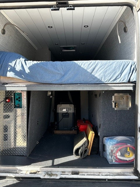  ocean waves beyond under cloudy sky.|Explore this RV rental's clever interior: high bed — photo 10