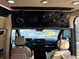 Inside an rv rental: A sleek interior with a large entertainment display, integrated speakers, and luxurious diamond-stitched seats.