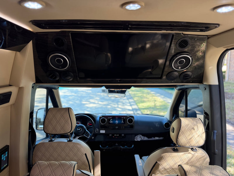Inside an rv rental: A sleek interior with a large entertainment display, integrated speakers, and luxurious diamond-stitched seats. — photo 12