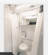 Interior of an RV rental bathroom: a compact, bright space with a toilet, sink, and integrated shower.