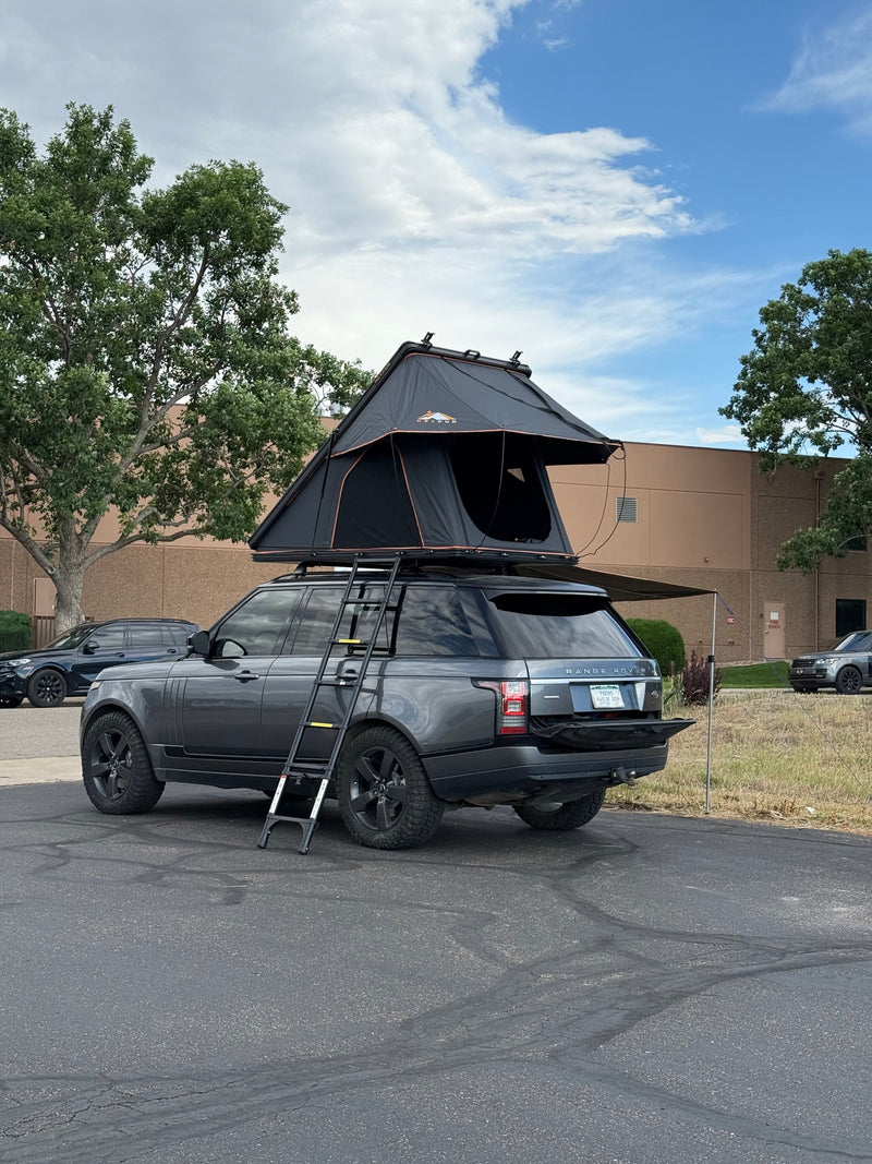 RV rental: Grey Range Rover SUV with deployed rooftop tent, ladder, and awning, ready for adventure camping. — photo 3