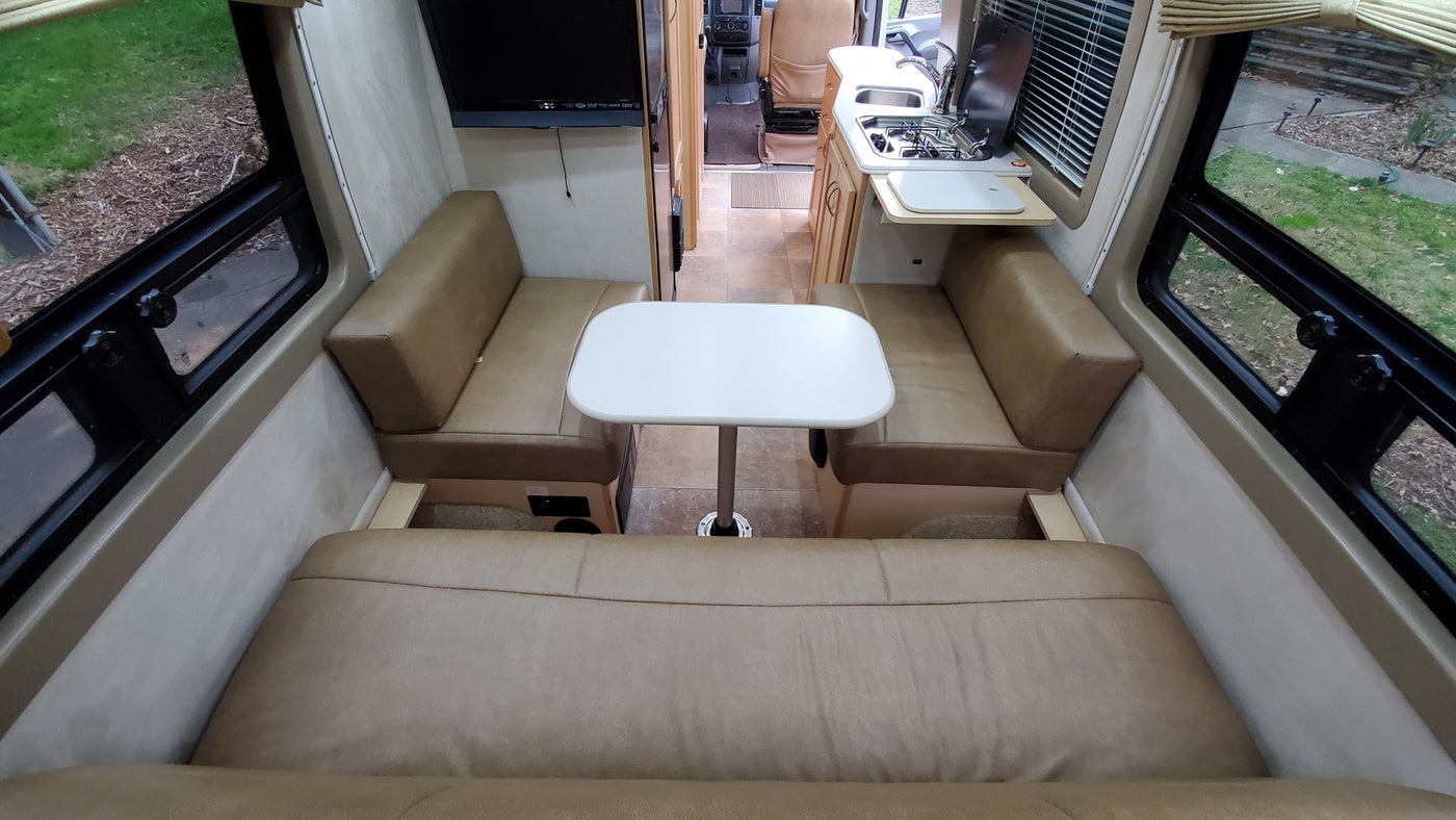  and cozy rear lounge seating.|RV rental kitchen: light counter with sink & stove — photo 11