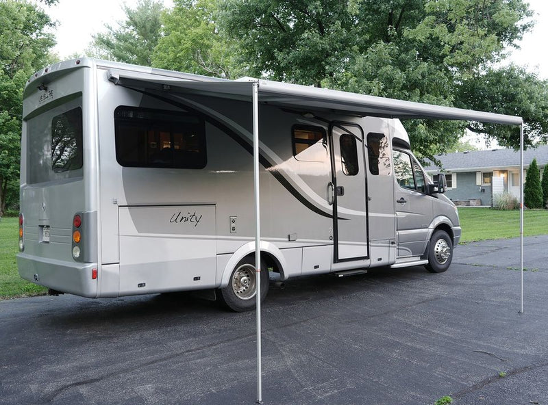  and an adjacent bathroom with shower & toilet.|Inside a compact RV rental — photo 8