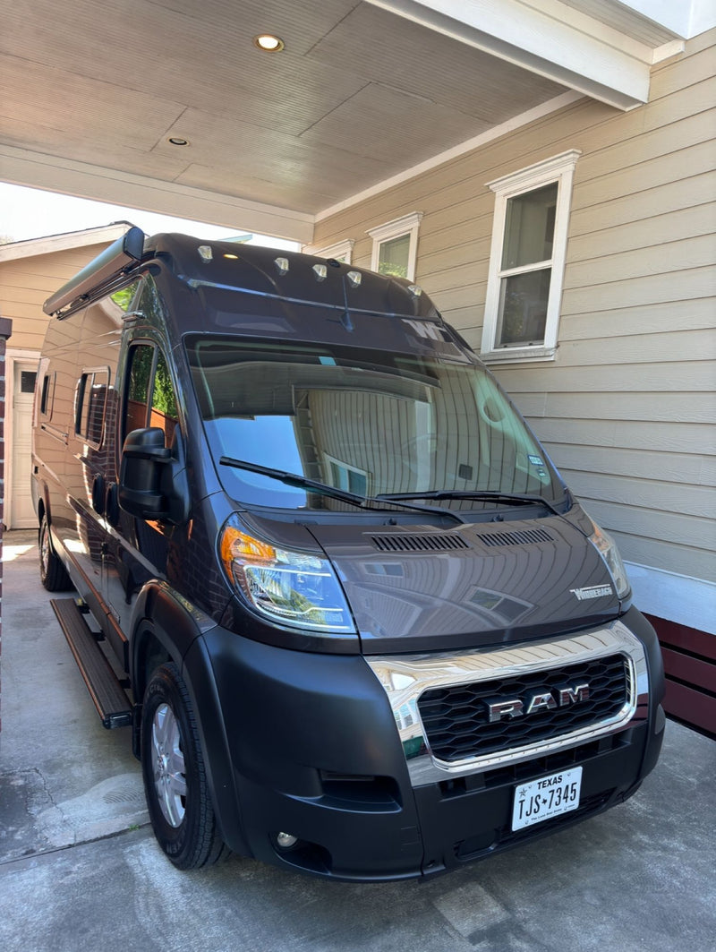  parked under a carport.|Winnebago Solis camper van (RV rental) plugged in — photo 5