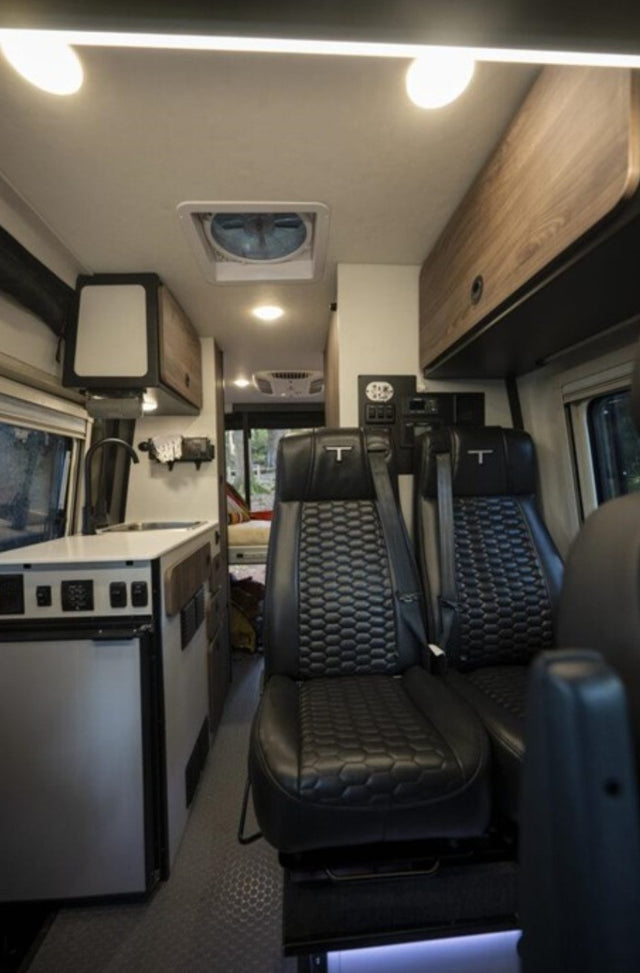  on a dirt road. Perfect for adventure travel.|Enjoying an RV rental adventure. A Tiffin camper van with its door open
