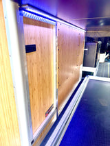 RV rental: View of an RV's custom bamboo kitchen and storage unit with blue LED lighting and pull-out drawer.