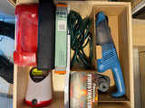 An RV rental drawer, neatly organized with camping essentials: firestarters, handheld vacuum, lantern, and various tools.