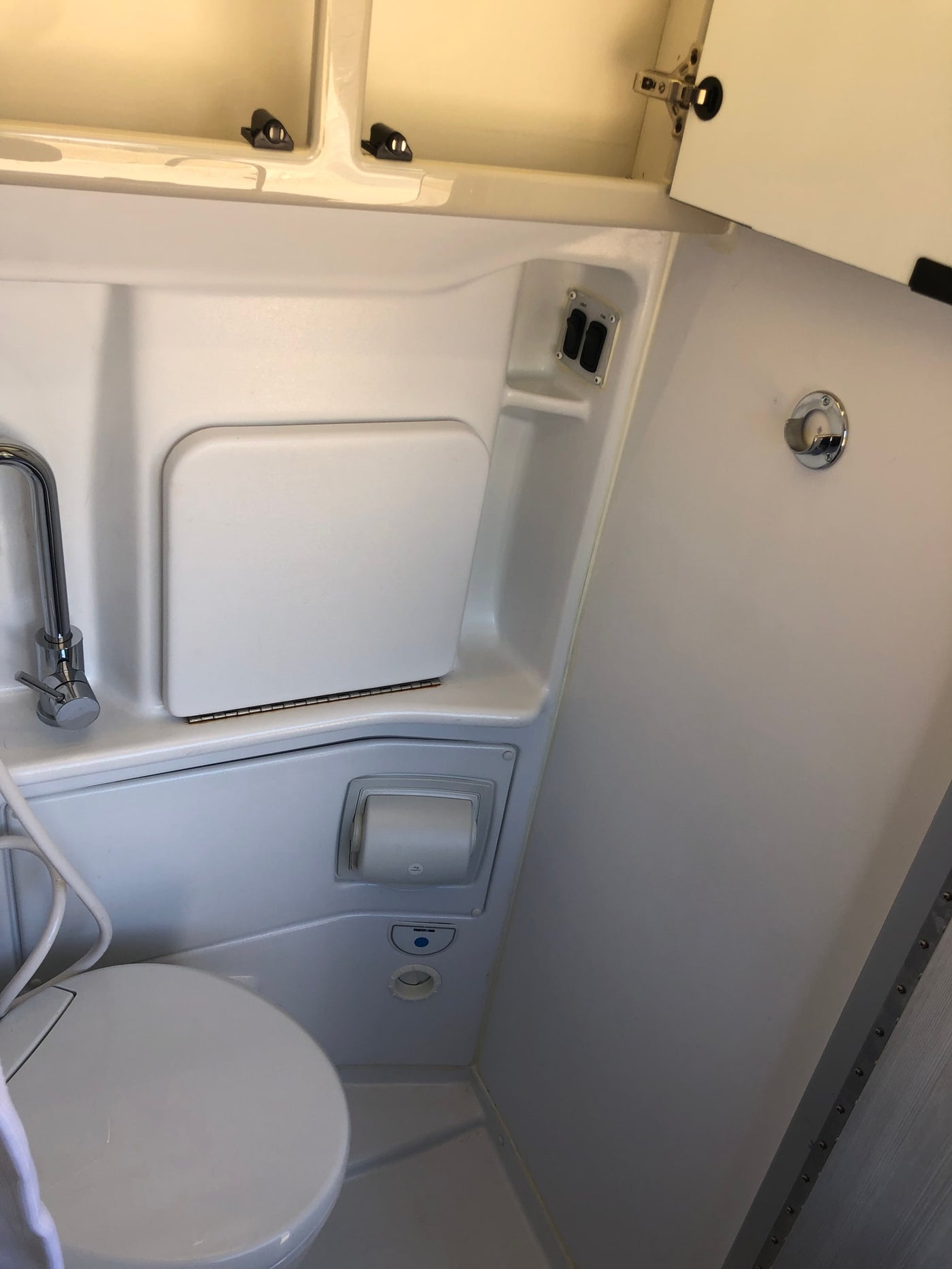  and a table base on wood-look flooring.|Step inside this inviting RV rental interior: compact kitchen — photo 10