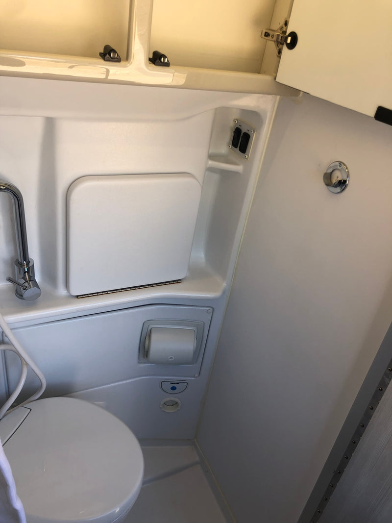  and a table base on wood-look flooring.|Step inside this inviting RV rental interior: compact kitchen — photo 10
