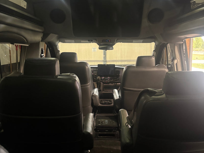  and unique headrest logos.|Clean RV rental interior: front cabin with leather seats — photo 3