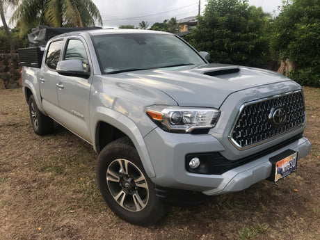 Gray Toyota Tacoma pickup with an overlanding setup, excellent for a Hawaii RV rental adventure.