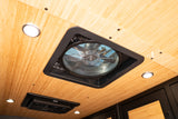 Bright RV rental interior ceiling with a central vent fan, recessed LED lights, and bamboo paneling.
